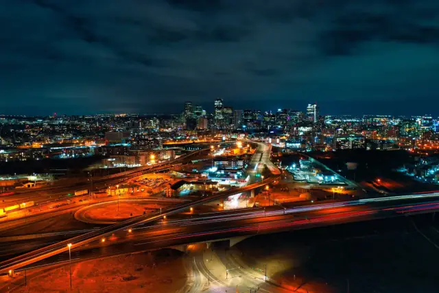 Night drone photo of the downtown Denver skyline and city lights
