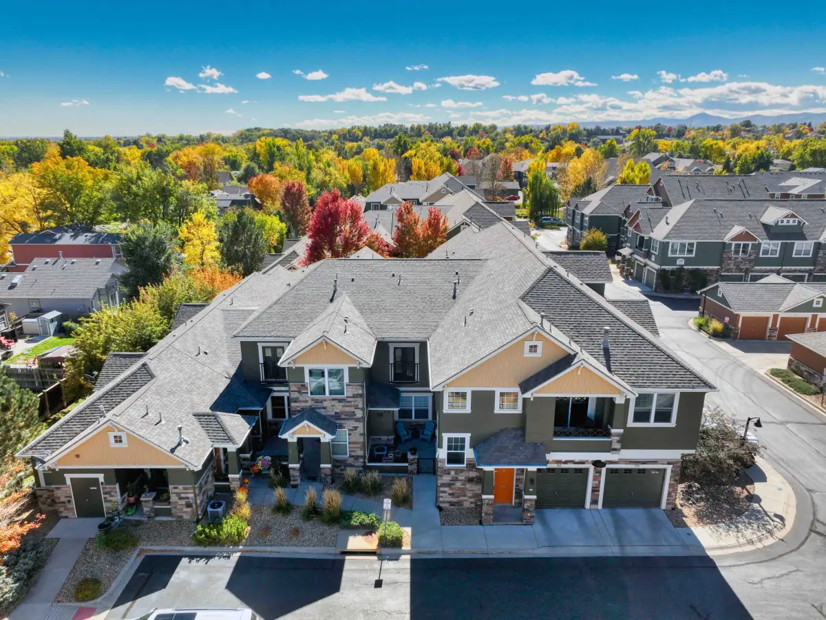 Drone photo of an Arvada residential property with neighborhood and mountain context